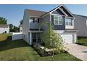 Charming two-story home featuring a two car garage, manicured landscaping, and mature trees at 3322 Brighton Dr, Gastonia, NC 28052