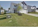 Landscaped front yard featuring mature trees, green grass, and a charming two-story home at 3322 Brighton Dr, Gastonia, NC 28052