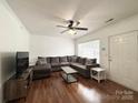 Bright living room featuring hardwood floors, a large sectional sofa, and a ceiling fan at 3602 Melrose Cottage Dr, Matthews, NC 28105
