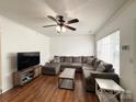 Cozy living room with hardwood floors, a comfortable sectional, and a stylish coffee table at 3602 Melrose Cottage Dr, Matthews, NC 28105