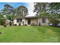 Well-maintained home with a lush green lawn and mature trees at 3623 Braden Dr, Charlotte, NC 28216