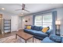 Cozy living room with lots of natural light, modern ceiling fan and a comfortable blue sofa at 3623 Braden Dr, Charlotte, NC 28216