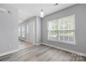Bright living room with new flooring and modern light fixture at 4004 Shasta Cir, Clover, SC 29710
