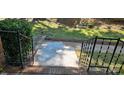 Front porch, featuring a black iron railing and brick steps at 401 Pamela St, Gastonia, NC 28054