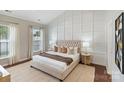 Serene main bedroom featuring paneled accent wall, neutral decor, and ample natural light at 4028 Woodsmill Rd, Fort Mill, SC 29707
