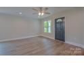 Living room with new laminate flooring, ceiling fan, recessed lighting, and a window view at 407 Chambers St, Statesville, NC 28677