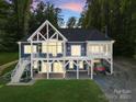 Beautiful two-story home featuring a large, covered deck and patio at 434 Breezewood Dr, Belmont, NC 28012