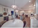 Bright, spacious kitchen featuring white cabinetry, stainless steel appliances, and a large center island at 5900 Colwick Nw Ct, Concord, NC 28027