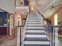 Elegant staircase with a white and black design, complemented by neutral wall colors and hardwood floors at 5900 Colwick Nw Ct, Concord, NC 28027