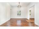 Bright dining room with hardwood floors, chandelier, and large window with plantation shutters at 6033 Bountiful St # 201, Belmont, NC 28012