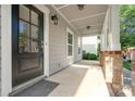 Inviting covered porch, featuring brick supports and stylish exterior lighting at 6033 Bountiful St # 201, Belmont, NC 28012