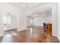 Open-concept living room with hardwood floors, neutral walls, and natural light at 6033 Bountiful St # 201, Belmont, NC 28012