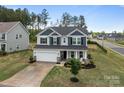 Well-maintained two-story home with a two-car garage and a neatly landscaped front yard at 7604 Tanglewood Way, Denver, NC 28037