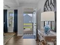 Inviting foyer with wood flooring, stylish decor, and an open view to the exterior at 7604 Tanglewood Way, Denver, NC 28037