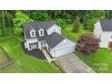 An aerial view shows this two-story home with lush landscaping, an attached garage, and well-maintained lawns at 8302 Holbrook Square Ct, Charlotte, NC 28216