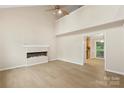 An open floor plan shows the cozy living room with fireplace and wood-look floors at 8302 Holbrook Square Ct, Charlotte, NC 28216