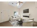 Inviting living room featuring a modern fireplace, vaulted ceilings, and stylish decor for comfortable living at 8302 Holbrook Square Ct, Charlotte, NC 28216