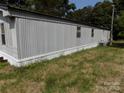 Side view of single-story home with neutral siding and a well maintained lawn at 868 Alexis High Shoals Rd, Dallas, NC 28034