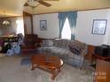 A traditional living room featuring a comfortable couch, armchair, and ceiling fan at 868 Alexis High Shoals Rd, Dallas, NC 28034