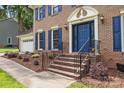 Inviting entrance with brick steps, metal railings, and a bright blue front door at 9001 Peyton Randolph Dr, Charlotte, NC 28277
