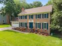 Lovely brick home with blue shutters, nice landscaping, and a spacious front yard at 9001 Peyton Randolph Dr, Charlotte, NC 28277