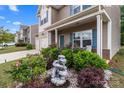Inviting front yard with a decorative fountain, vibrant flowers, and lush greenery enhancing curb appeal at 9132 Colwick Hill Ln, Charlotte, NC 28215