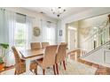 Charming dining room featuring natural lighting, hardwood floors, and an entrance to the foyer at 916 Cadogan Ct, Fort Mill, SC 29708