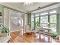 Inviting living room with hardwood floors, large windows, and adjacent to a staircase at 916 Cadogan Ct, Fort Mill, SC 29708