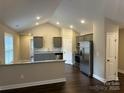 Bright and airy kitchen featuring modern appliances, granite countertops, and stylish gray cabinetry at 003 West Ave, Wadesboro, NC 28170