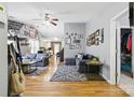 Open-concept living room with hardwood floors, ceiling fan and comfortable seating at 1006 Washburn Ct, Monroe, NC 28110