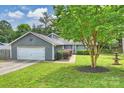 Inviting exterior view of home featuring fresh landscaping and mature tree at 11619 Rimrock Canyon Dr, Charlotte, NC 28226