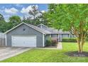 Charming exterior features a well-manicured lawn and an attached garage at 11619 Rimrock Canyon Dr, Charlotte, NC 28226