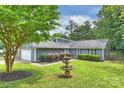 Well-manicured lawn with mature trees and a decorative fountain enhance the curb appeal at 11619 Rimrock Canyon Dr, Charlotte, NC 28226