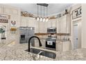 Bright kitchen featuring stainless steel appliances, granite countertops, and custom cabinetry at 149 Harbor Landing Dr, Mooresville, NC 28117