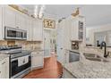 Well-lit kitchen with stainless steel appliances, granite countertops, and wood floors at 149 Harbor Landing Dr, Mooresville, NC 28117
