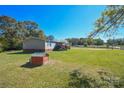 This home features a large back yard with a dog house at 1574 Burke Duncan Rd, Lancaster, SC 29720