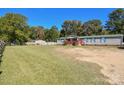 Wide view of the home showing its large front yard and the home's green roof at 1574 Burke Duncan Rd, Lancaster, SC 29720
