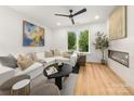 Cozy living room with a white sectional sofa, decorative fireplace, and lots of natural light at 158 Mattoon St, Charlotte, NC 28216