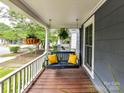 Cozy front porch featuring a swing, hanging plants, and relaxing outdoor space at 1605 Allen St, Charlotte, NC 28205