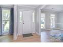 Bright entryway featuring beautiful wood floors, fresh paint, and sidelight windows at 16433 Grapperhall Dr, Huntersville, NC 28078