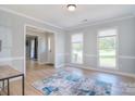 Inviting living room with wood floors, neutral paint, and large windows for ample natural light at 16433 Grapperhall Dr, Huntersville, NC 28078