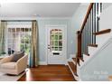 Welcoming entryway featuring hardwood floors, staircase, and front door with window panes at 236 Wales Ave, Charlotte, NC 28209