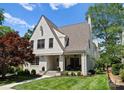 A beautifully landscaped white brick home with a covered front porch and mature trees at 236 Wales Ave, Charlotte, NC 28209