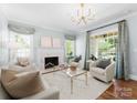 Bright and airy living room featuring a fireplace, neutral decor, and large windows at 236 Wales Ave, Charlotte, NC 28209
