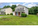 Attractive two-story home featuring gray siding, a brick accent, a lush green lawn, and an attached single-car garage at 2903 Rockingham Sw Ct, Concord, NC 28025