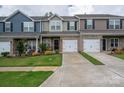 Charming townhomes featuring mixed material exteriors and attached one car garages at 348 Zocalo Dr, Gastonia, NC 28056