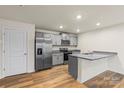 Modern kitchen with stainless steel appliances, gray cabinets, and granite countertops at 4116 Lurelin Ln, Charlotte, NC 28262