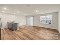 Open-concept living room with hardwood floors and lots of natural light at 4116 Lurelin Ln, Charlotte, NC 28262
