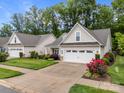 Home featuring an attached two car garage, neat landscaping, and an extended driveway at 422 Drake Ln, Salisbury, NC 28146