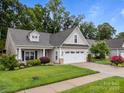 Well-kept home with a two-car garage, cozy front porch, and a manicured front yard at 422 Drake Ln, Salisbury, NC 28146